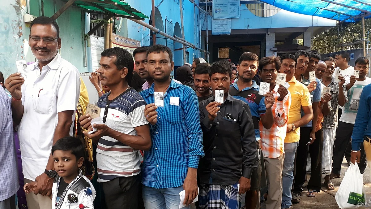 People stand in a queue to cast their vote at a polling station in Barrackpore in North 24 Parganas district of West Bengal (IANS Photo)