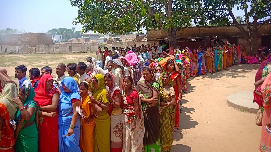 People wait in multiple queues to cast their votes