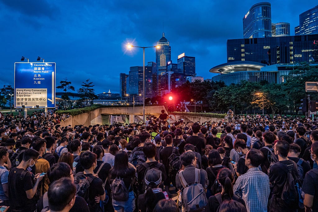 Silent sit-in escalates as Hong Kong protesters gather outside parliament and police HQ after end of ultimatum
