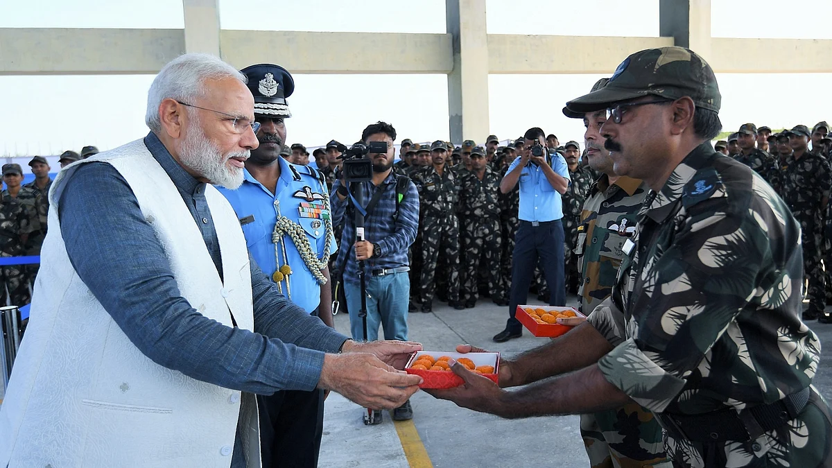 PM Modi distributing laddu to soldiers in Rajouri, Jammu and Kashmir on Diwali day, October 27, 2019 (Photo courtesy: PIB)