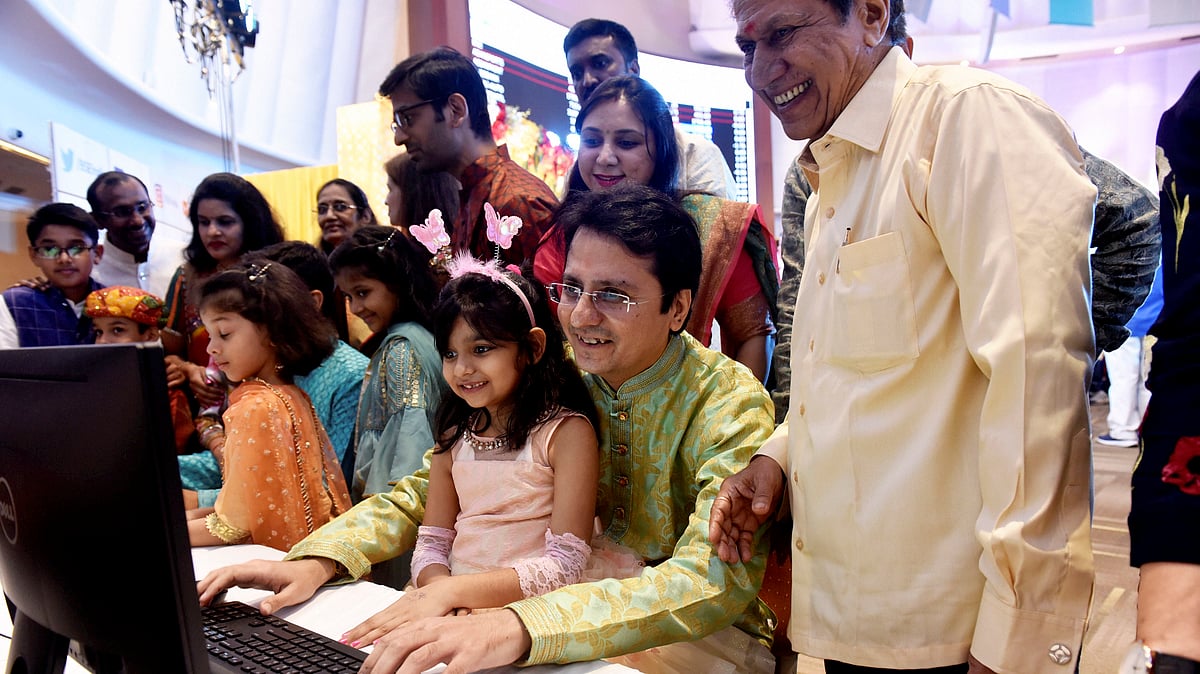 Stockbrokers trade as their families watch during a special ‘muhurat’ trading session for Diwali at BSE in Mumbai on Sunday, Oct 27 (PTI Photo).