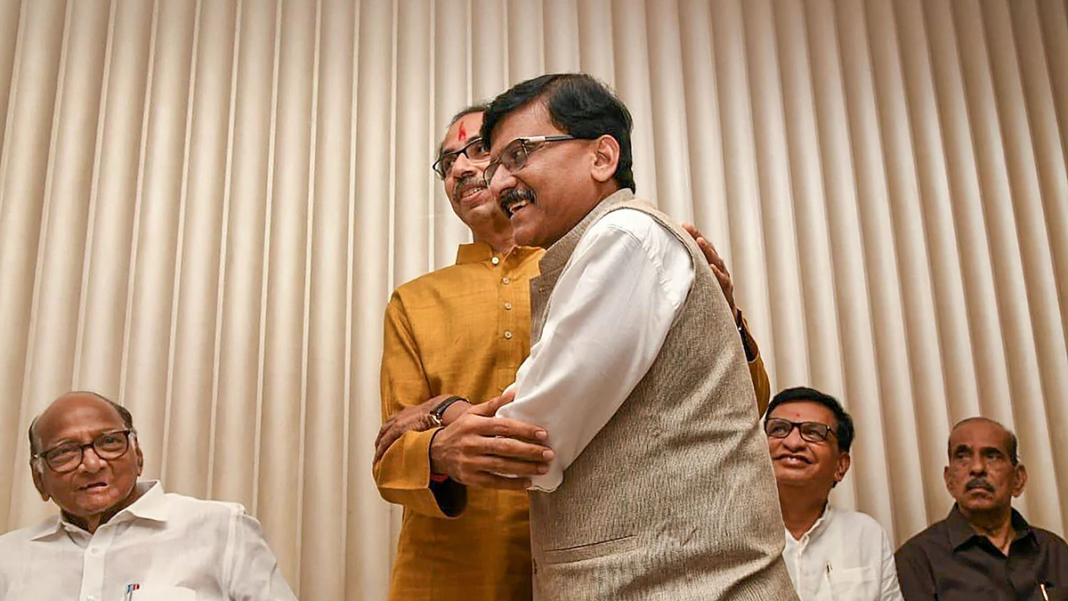 Sena chief Uddhav Thackeray being greeted by party leader Sanjay Raut after he was chosen as the nominee for Maharashtra chief minister’s post by Shiv Sena-NCP-Congress alliance, during a meeting in Mumbai, Tuesday, Nov 26, 2019. (PTI Photo)