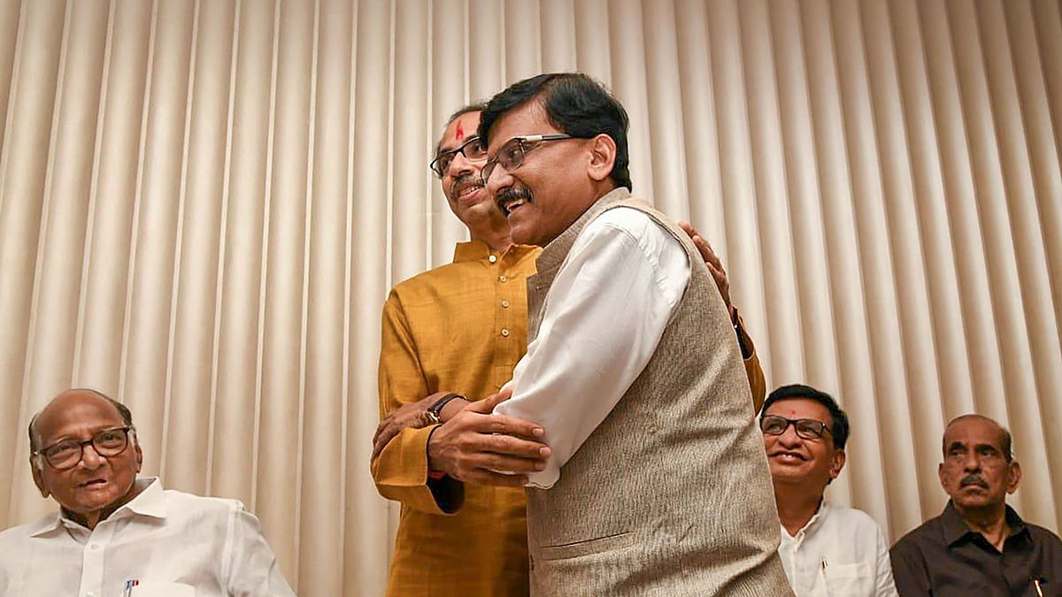 Sena chief Uddhav Thackeray being greeted by party leader Sanjay Raut after he was chosen as the nominee for Maharashtra chief minister’s post by Shiv Sena-NCP-Congress alliance, during a meeting in Mumbai, Tuesday, Nov 26, 2019. (PTI Photo)