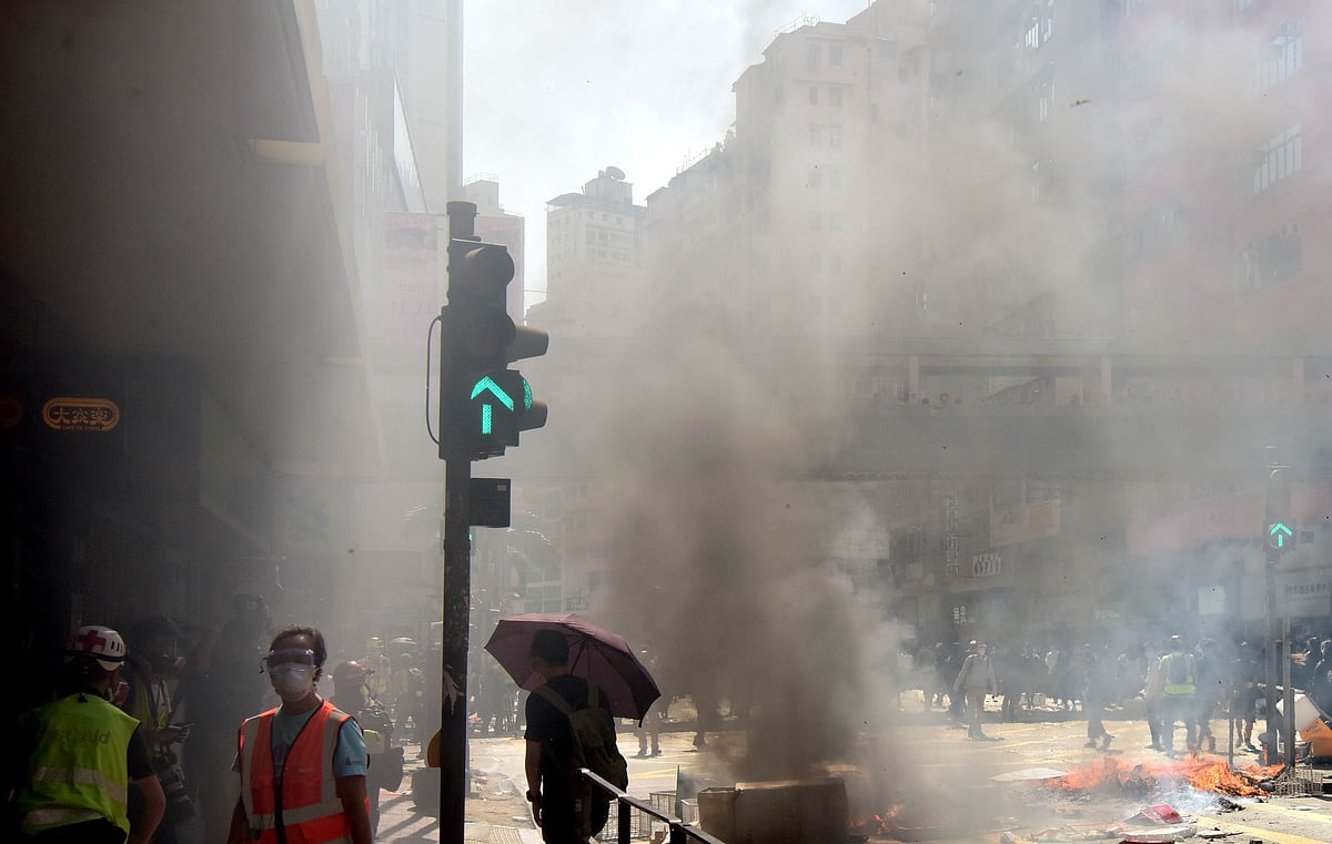 Hong Kong official hurt in London as protesters surround her