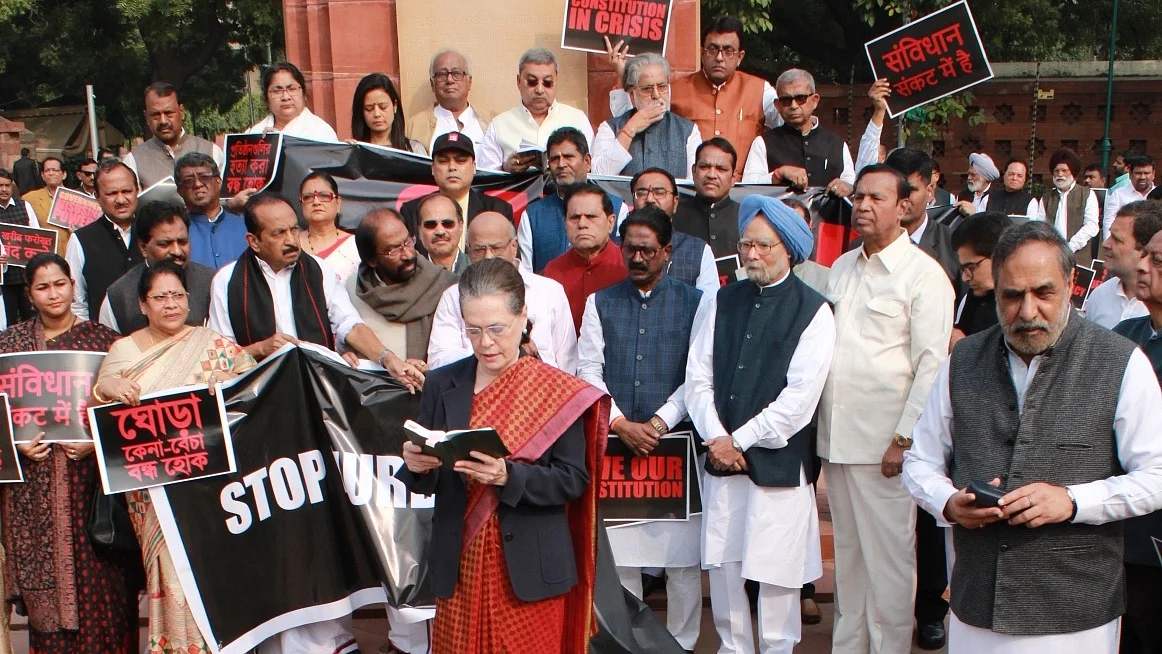 Congress president Sonia Gandhi reads the preamble of Constitution in front of Ambedkar statue in Parliament House on Constitution Day as Opposition parties protest on Nov 26, 2019.