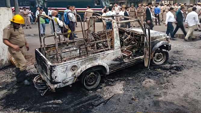 A police vehicle allegedly set on fire by the rampaging lawyers at Tis Hazari district court in Delhi on Nov 2. (PTI photo)