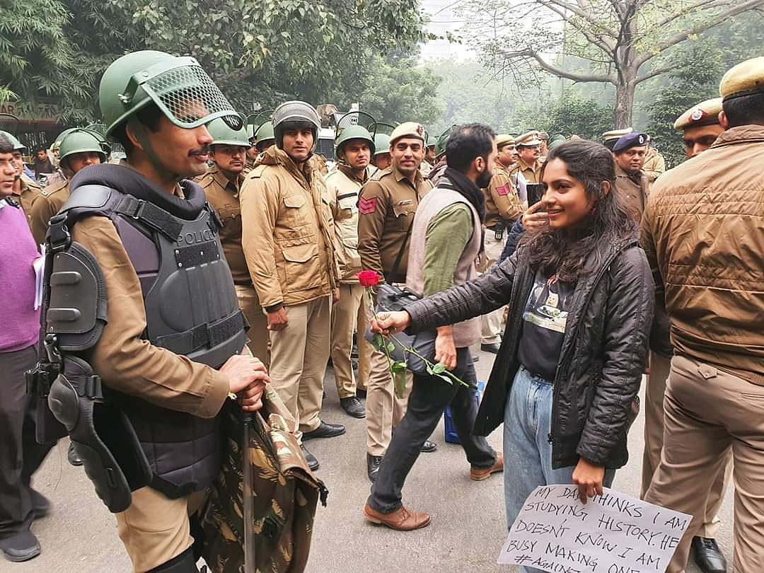 Unique style of protest: In Delhi, protesters offer roses to policemen to shun hatred, violence