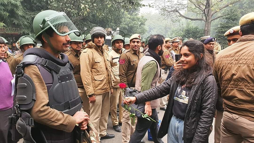 Unique style of protest: In Delhi, protesters offer roses to policemen to shun hatred, violence