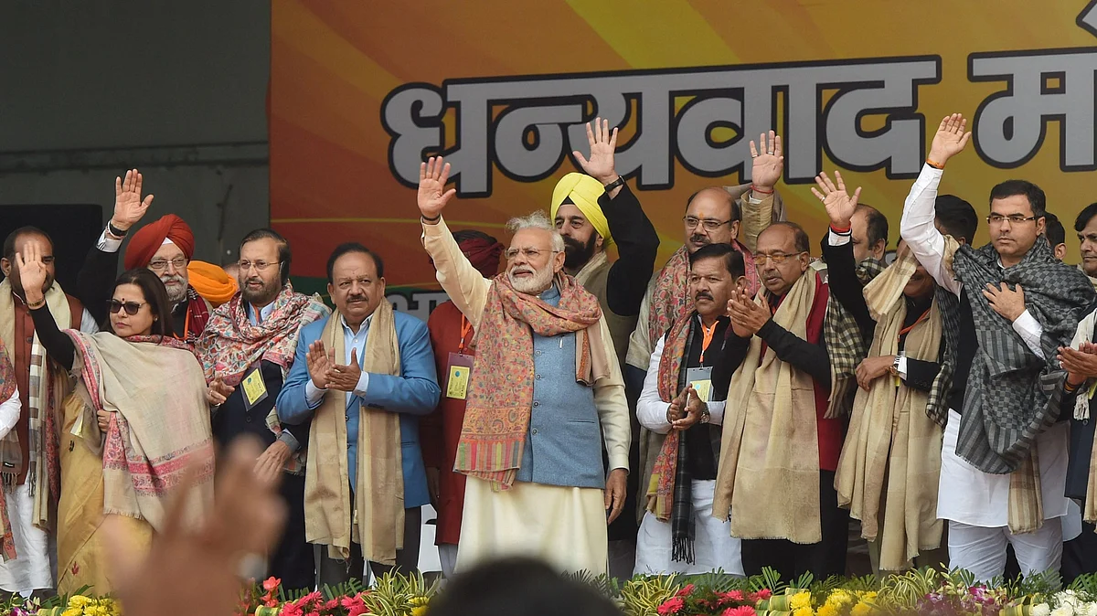 PM Narendra Modi along with BJP leaders Vijay Goel, Meenakshi Lekhi, Harsh Vardhan and others wave at supporters during a BJP rally at Ramlila Maidan in New Delhi on Sunday, Dec 22, 2019 (PTI Photo)