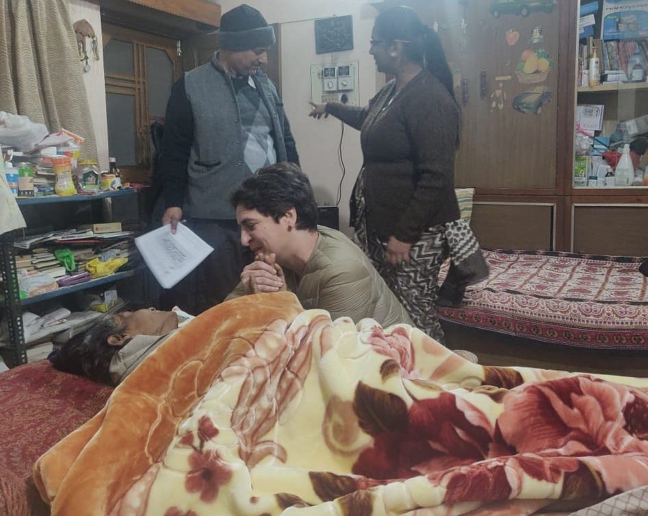 Priyanka Gandhi consoles the elderly, bed-ridden Mrs Darapuri whose husband has been arrested by police. The family doesn’t know of his whereabouts.