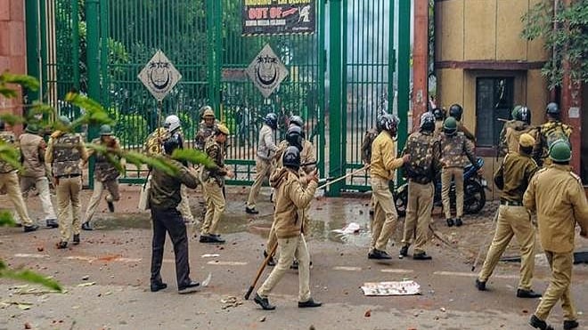 Police personnel outside Jamia Millia Islamia as students stage a protest against the Citizenship (Amendment) Act (PTI Photo)