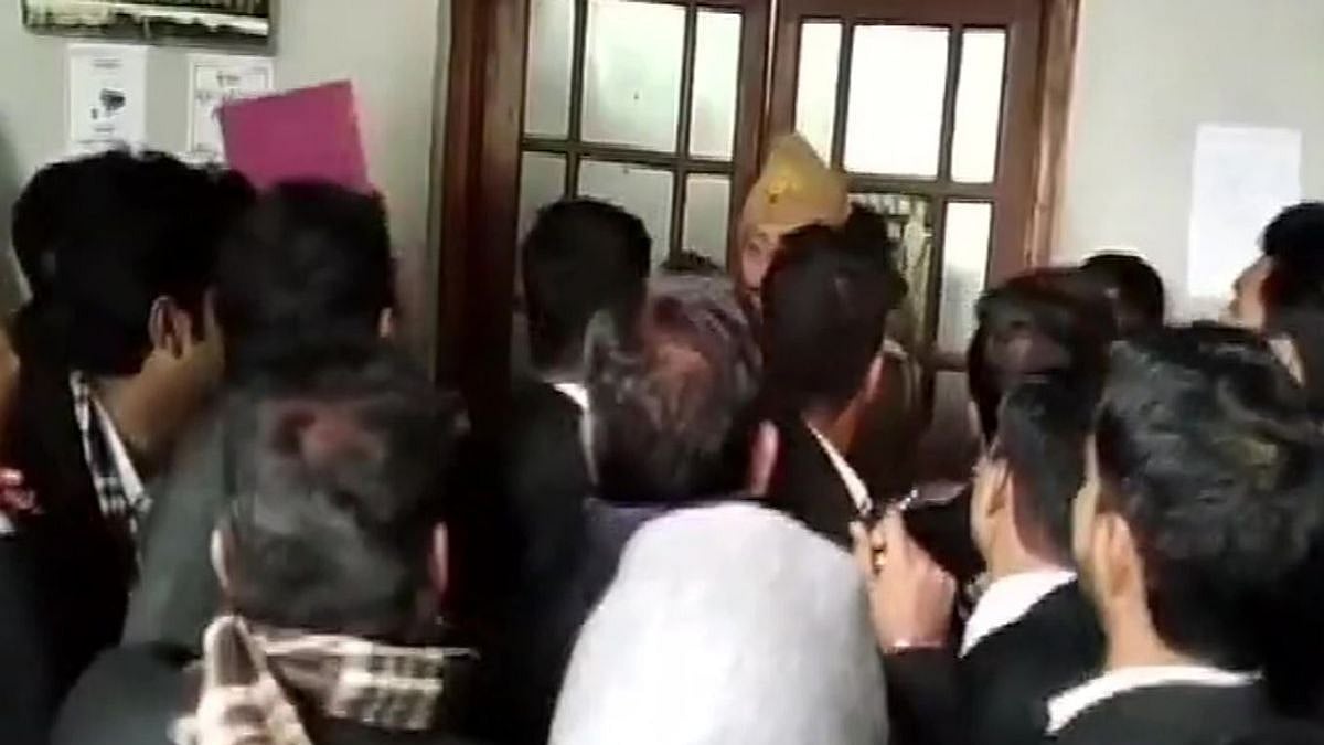 An accused of killing two people was shot dead by three men inside the district court on Tuesday