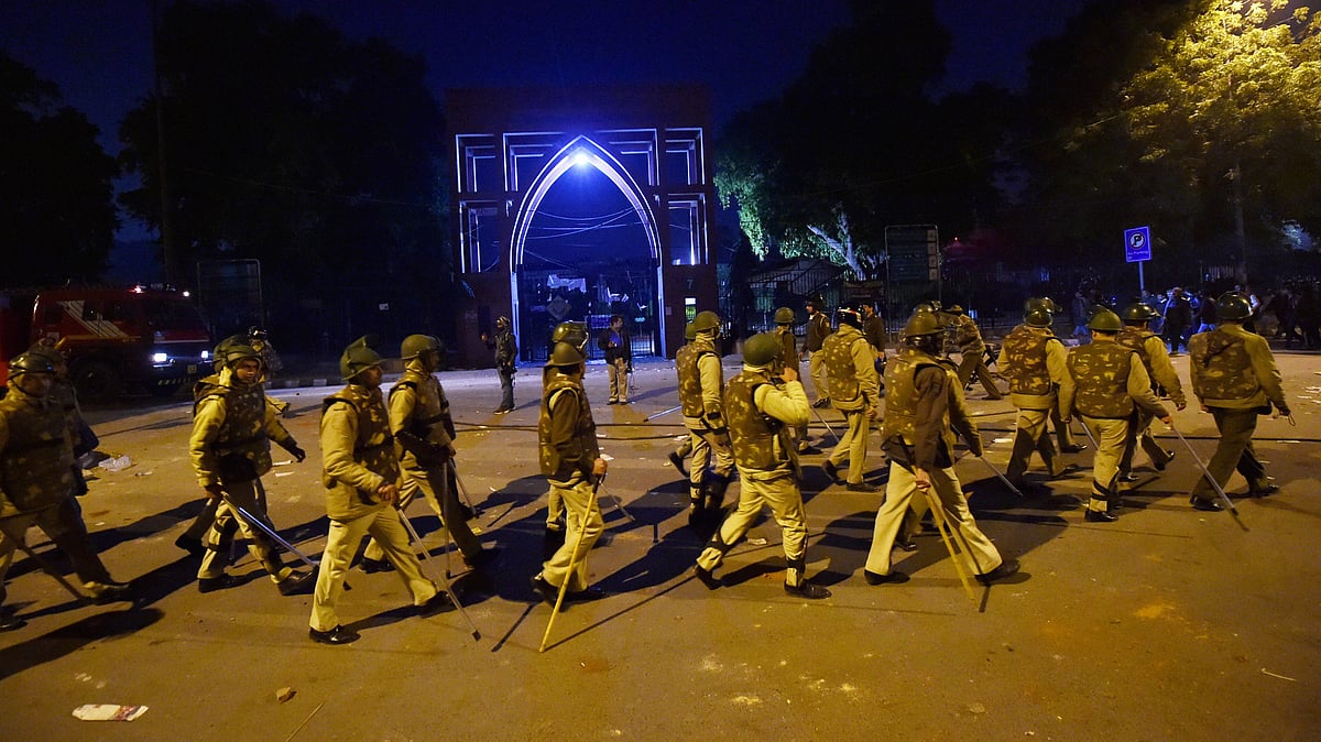 Policemen stand guard near Jamia Millia Islamia following the protests against Citizenship Amendment Act, in New Delhi, Sunday, Dec. 15, 2019 (PTI Photo)