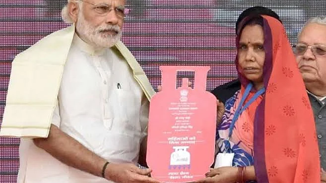PM Narendra Modi with a Ujjwala beneficiary
