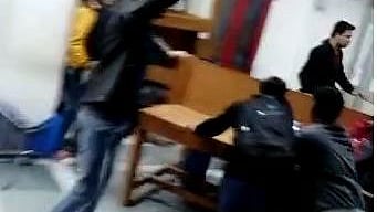 Panic stricken students inside Jamia library scramble to take cover as glass shards fly around due to teargas shells firing by Delhi police from outside. (File Photo)