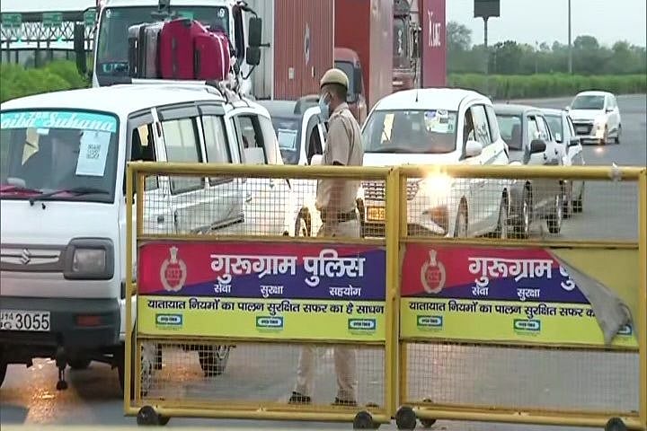 Policemen checking ‘pass’ and identity card of people at Delhi-Gurugram border