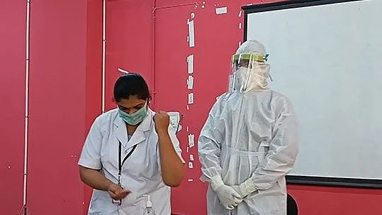 Air India Staff  learning to wear PPE gear before their flight to UAE to bring back Indians