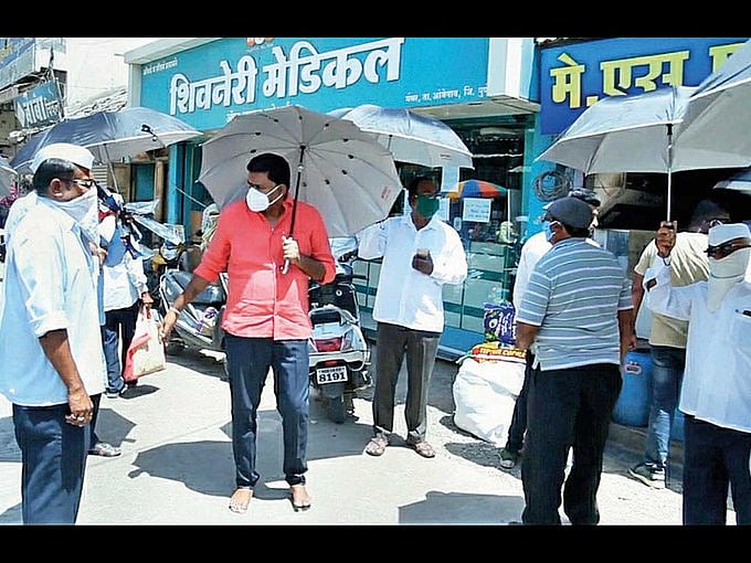 Maharashtra: Pune village uses umbrella as social distancing tool