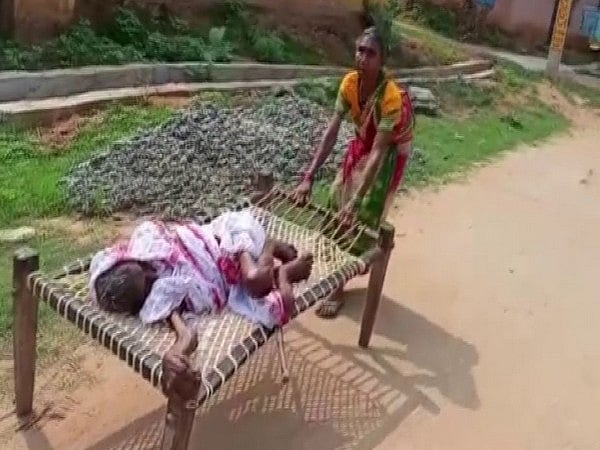 70-yr-old woman drags mother on cot to bank