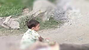 Photo of toddler sitting atop grandfather’s body latest addition to list of children caught in J&K conflict