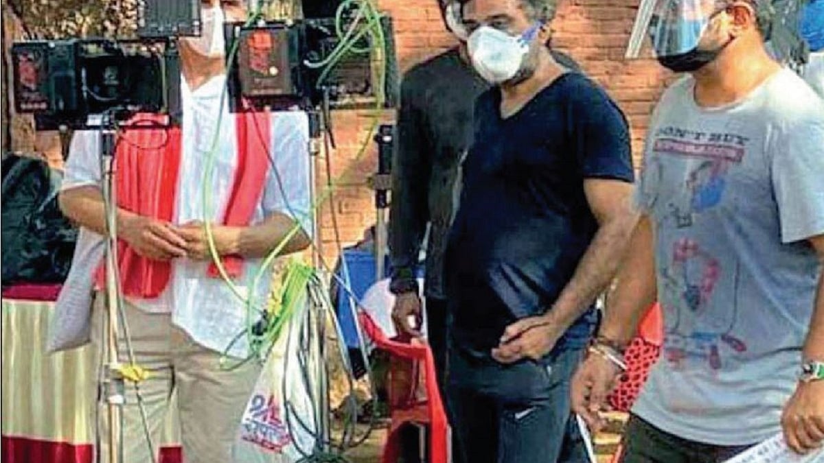 Actors and technicians sport masks during shooting of a film 