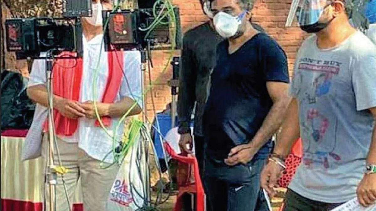 Actors and technicians sport masks during shooting of a film 