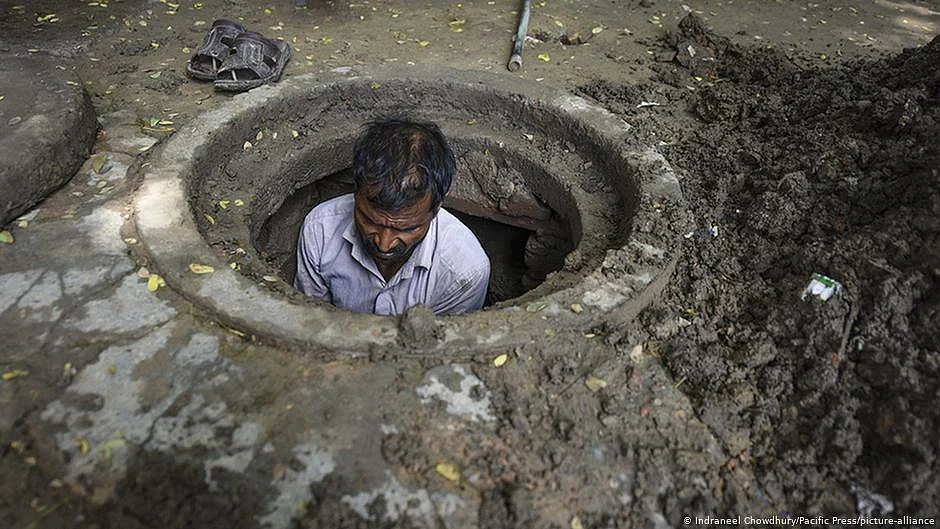 A sanitation worker cleans sewer