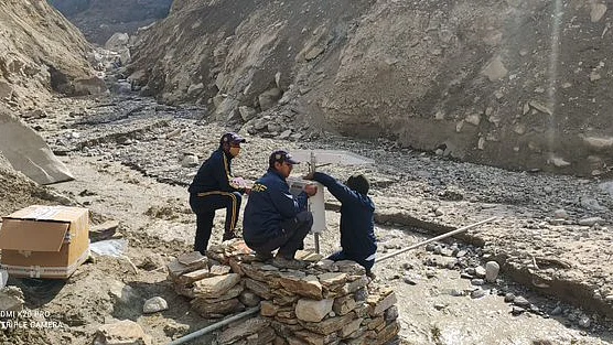 SDRF personnel installing an alarm device at the lake formed near Raini village in Uttarakhand’s Chamoli district for prior warning of any future flash floods