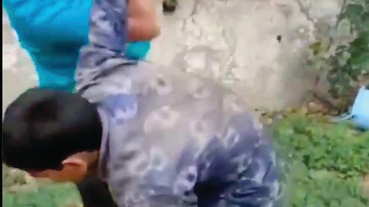 A 12-year-old Muslim boy, Asif, being thrashed by a man inside Dasna Devi temple in UP’s Ghaziabad for entering the temple