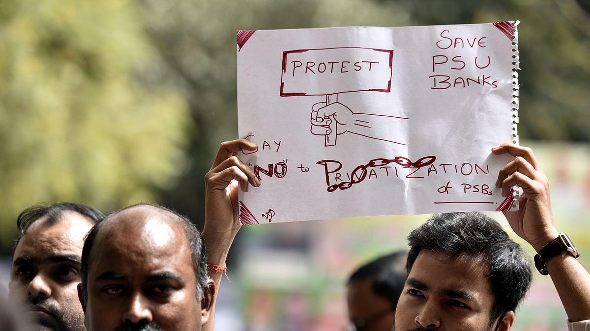 Employees of various government banks hold a banner as they shout slogans during a protest against the Privatization of Public Sector Banks during a two-day Nationwide strike (Photo by Sonu Mehta/Hindustan Times via Getty Images)