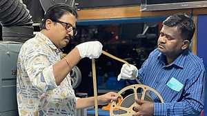 Prakash Magdum, Director, NFAI and Kiran A. Dhiwar, Film Preservation Officer, NFAI with a rare discovered reel on the making of Pakeezah