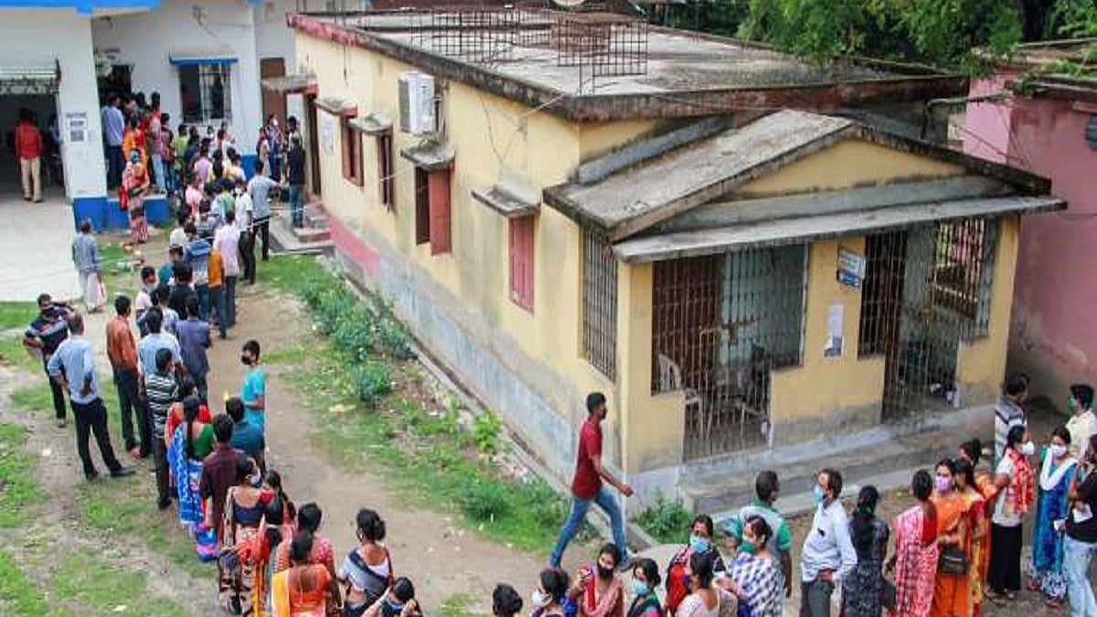People standing in a queue to receive COVID-19 vaccine at a government-run hospital 