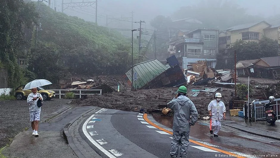 Rescuers slog through mud in Japan resort where 20 missing