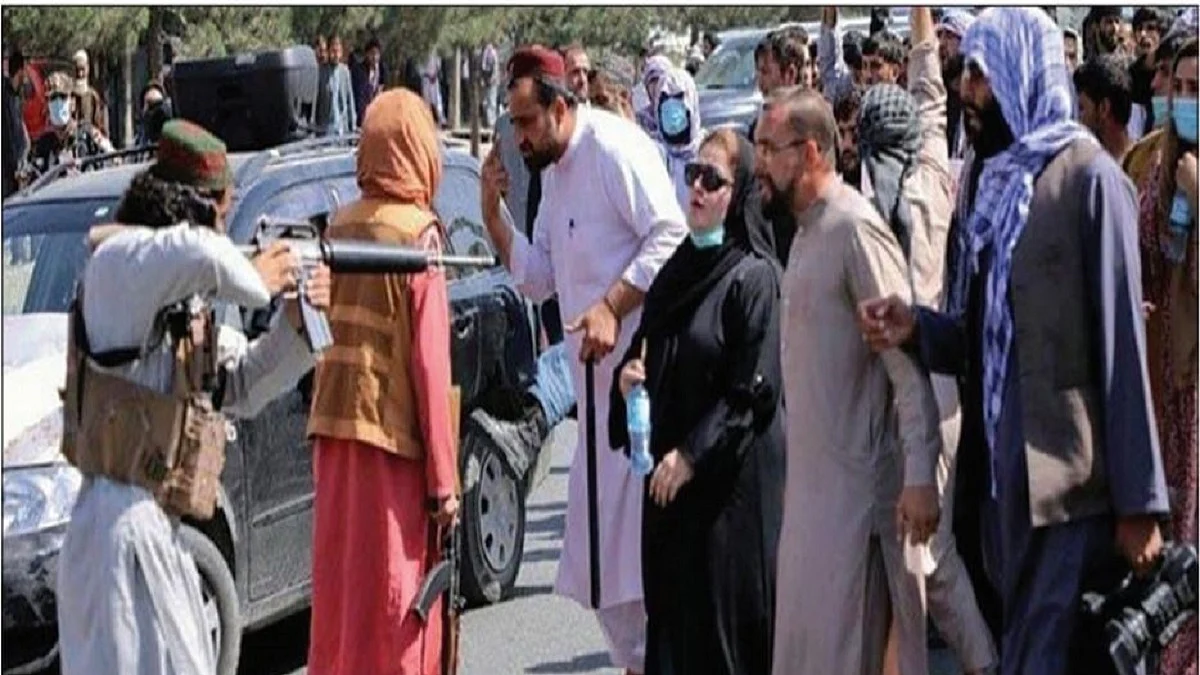 Taliban pointing a rifle at a woman