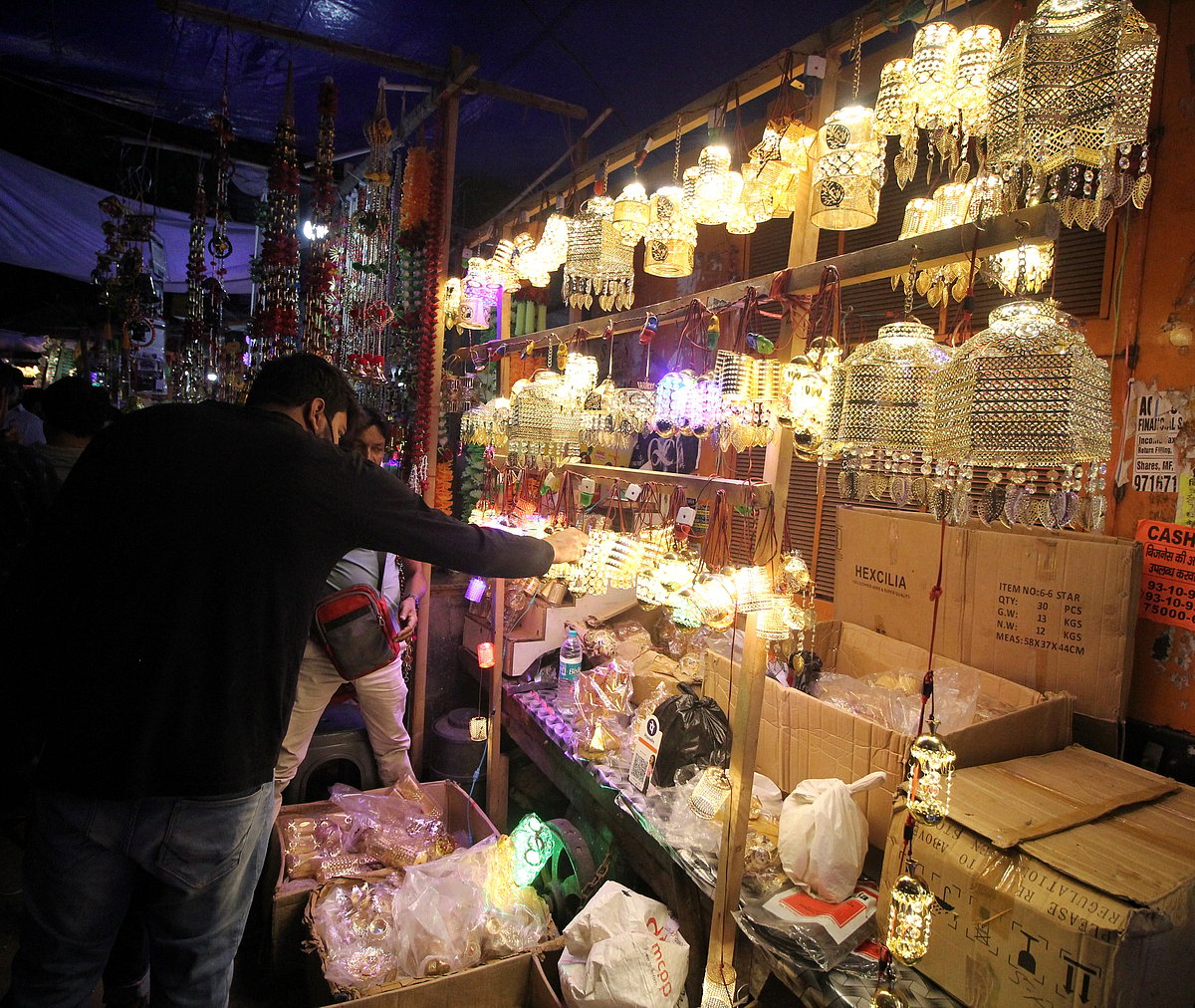 A vendor sells handicraft decorative lamps at Bhagirath Place