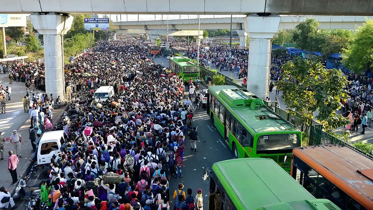 Thousands of migrant workers thronged Anand Vihar ISBT to catch a bus home after Modi announced sudden nationwide lockdown