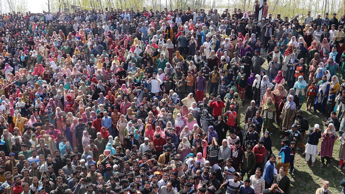 People carry the dead bodies of policeman Ashfaq Ahmad and his brother who were killed in Budgam district of Central Kashmir