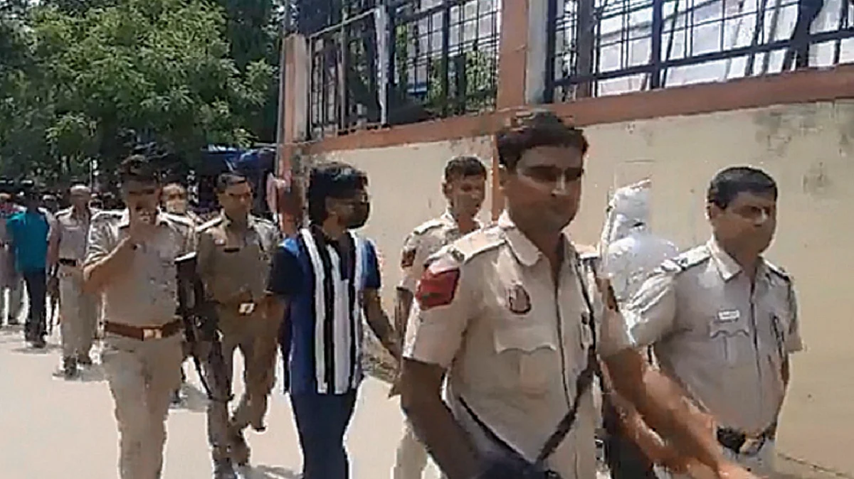Screengrab from a video showing armed policemen escorting Zubair
