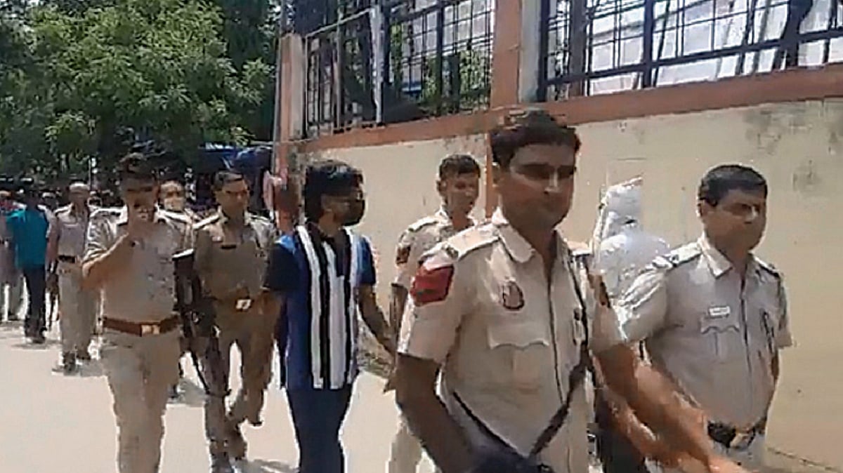 Screengrab from a video showing armed policemen escorting Zubair