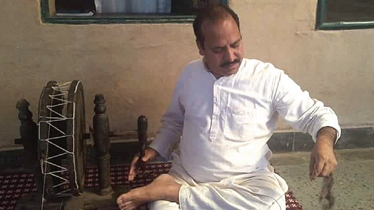 Himanshu Kumar, a Gandhian, works the spinning wheel (Charkha).