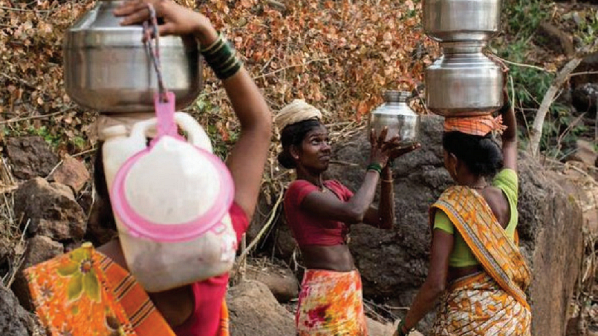 Tribal women carry water in handas