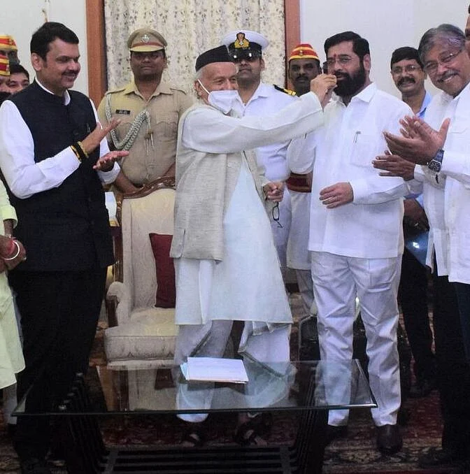Mission Accomplished? Maharashtra Governor BS Koshyari (centre) feeds sweets to Shiv Sena rebel Eknath Shinde after administering oath as CM to the latter 