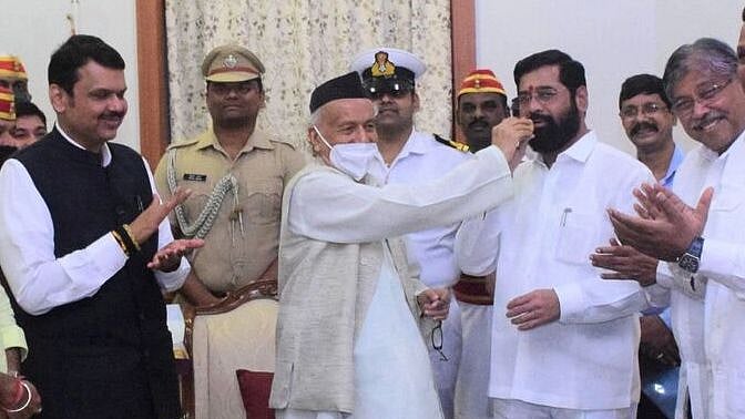 Mission Accomplished? Maharashtra Governor BS Koshyari (centre) feeds sweets to Shiv Sena rebel Eknath Shinde after administering oath as CM to the latter 