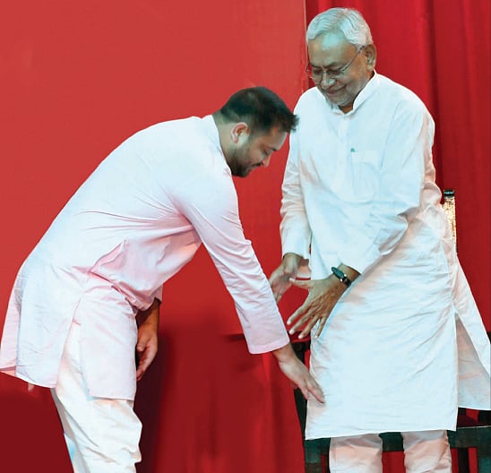 Tejashwi Yadav touches Nitish Kumar’s feet after taking oath