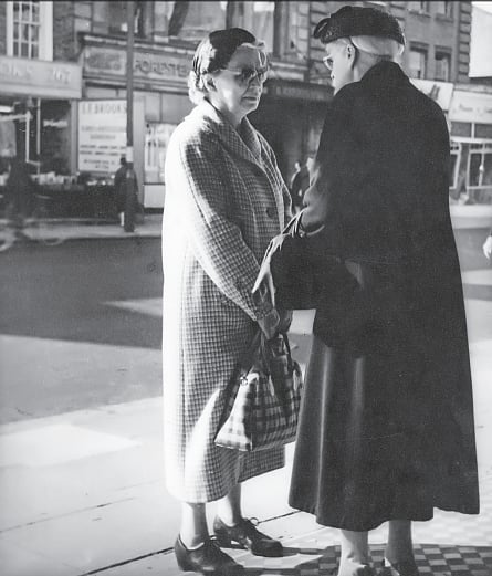 Two ladies meet on the road in London just to say “what a lovely day” - they are so lonely that just to be able to talk to someone is a relief, London, c.1959 by Manobina Roy