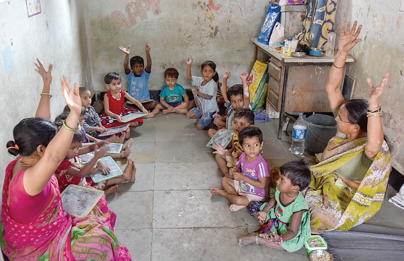 Anganwadi workers tending to children at a centre