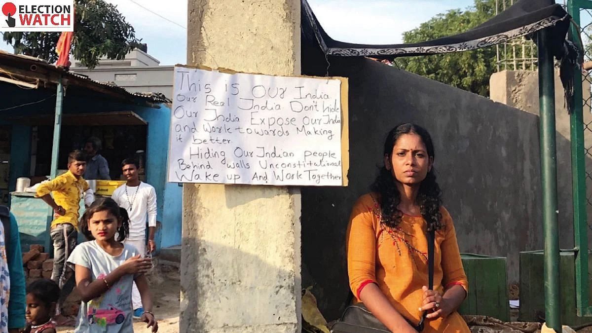 An activist protests against a wall built in front of a slum in Ahmedabad before US President Donald Trump's visit in February 2020 (Photo: Getty Images)