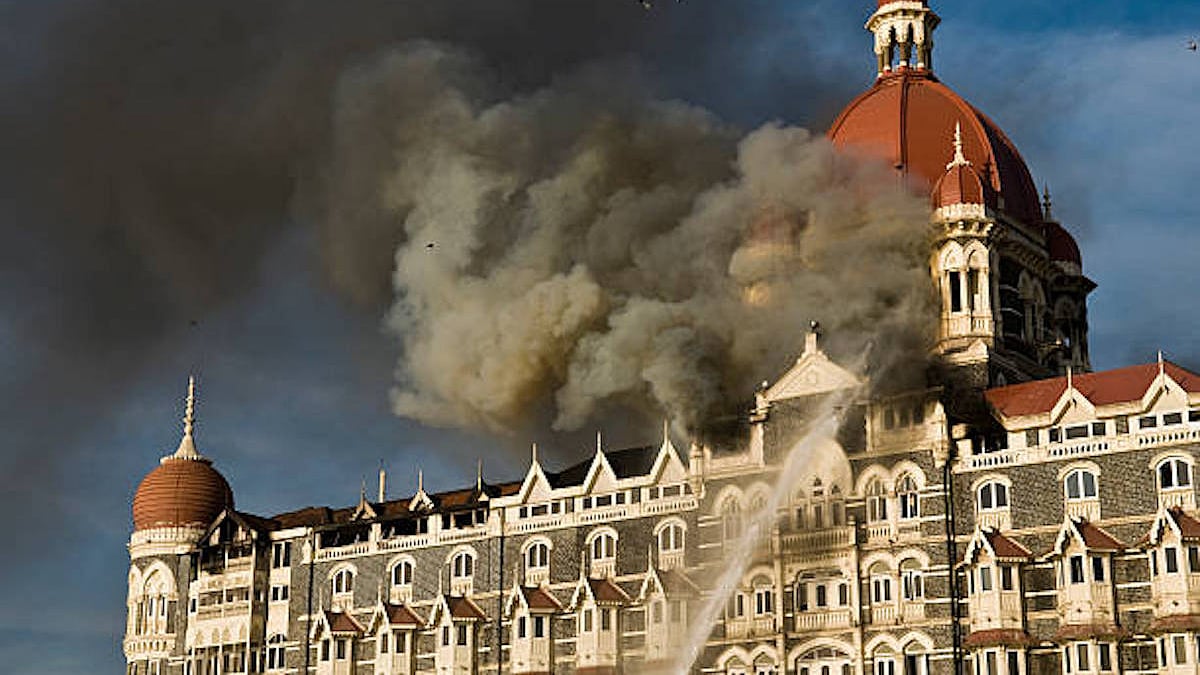 Smoke rises from the Taj Mahal Hotel, set ablaze by terrorists, in Mumbai on 27 Nov 2008