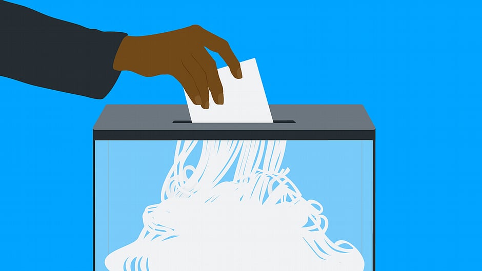 When democracies falter, they rarely recover. Representative image shows a ballot paper being inserted into the slot of a box and emerging below in strings, as though from a paper shredder (image: National Herald archives)