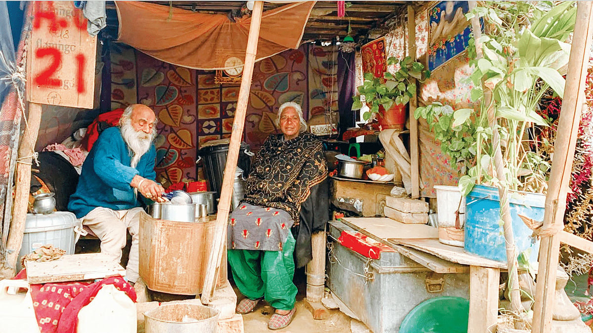 Jhanki with Ramkumar at his makeshift tea stall near Prem Nagar bus stand. She can afford to travel to her husband’s shack only once a month